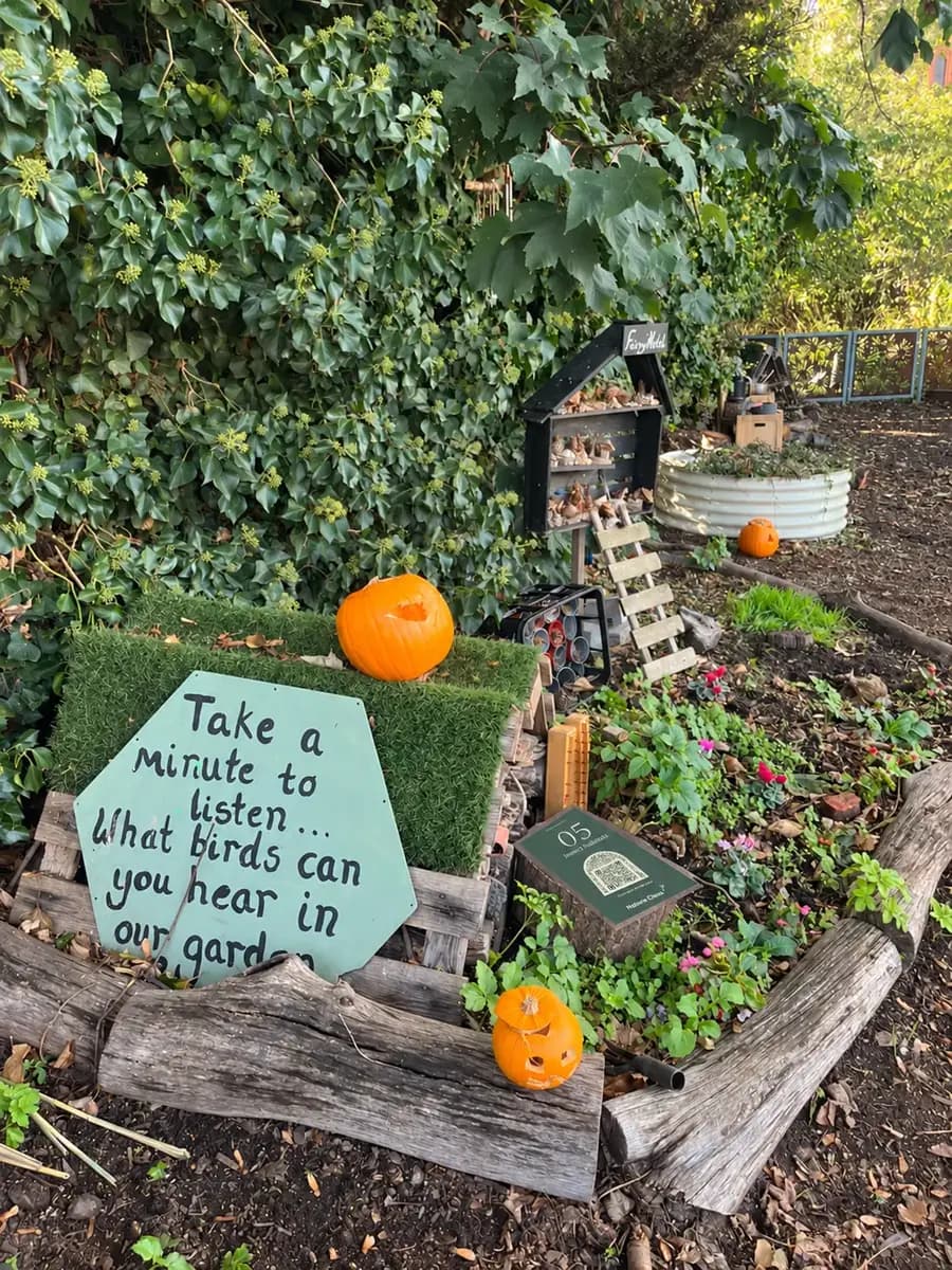 A painted board: Take a minute to listen. What birds can you hear in our garden?
