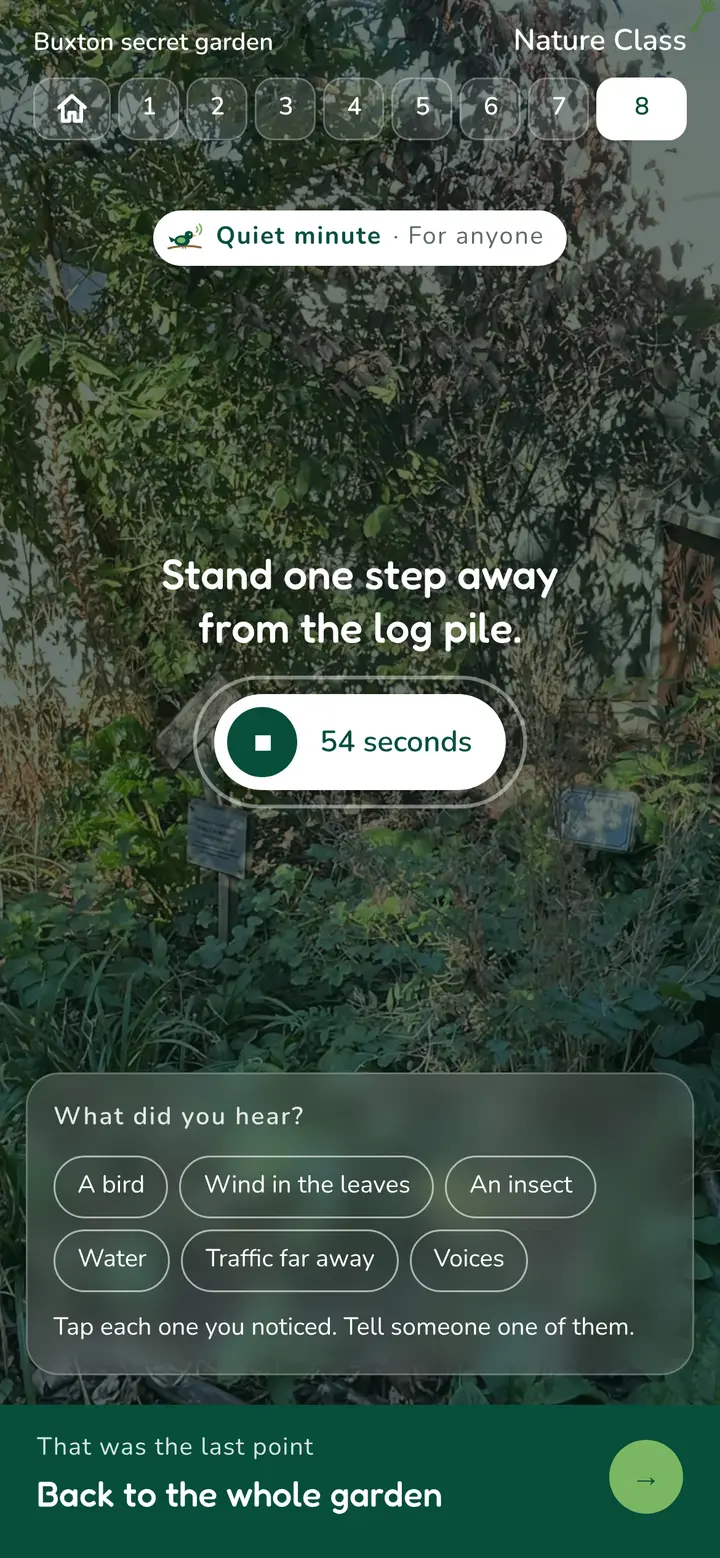 Phone screen of the quiet minute running at the wildlife space, over a photo of the log pile: Stand one step away from the log pile, 54 seconds left, and what did you hear: a bird, wind in the leaves, an insect, water, traffic far away, voices